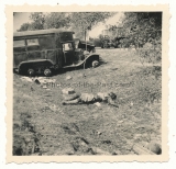 Toter Soldat vor einem LKW Wrack
